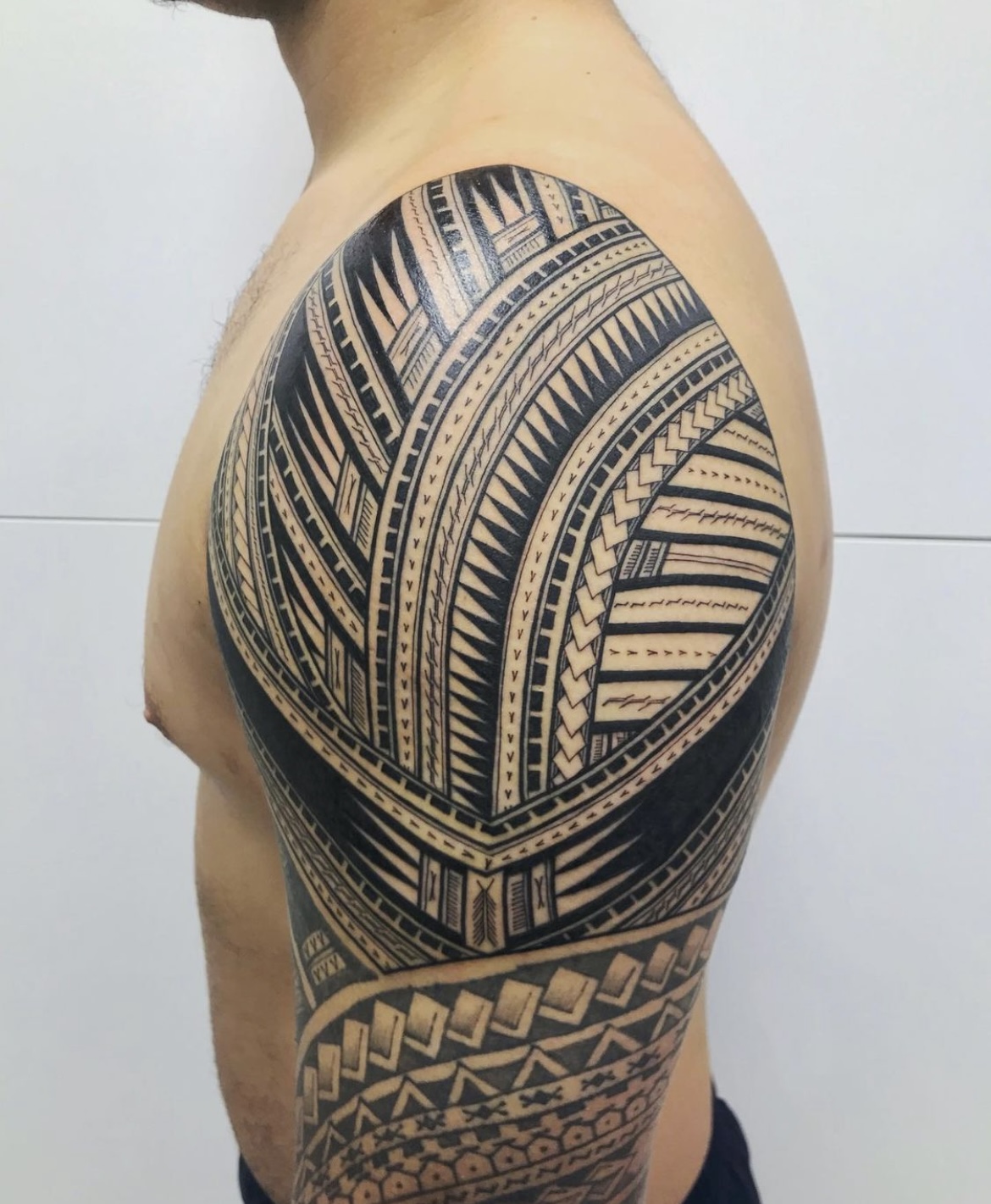 Image showcasing traditional Polynesian tattoo motifs, including intricate patterns and symbolic designs.
